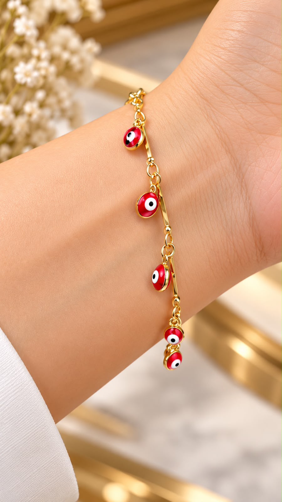 Pulsera Ojitos rojos Oro Laminado
